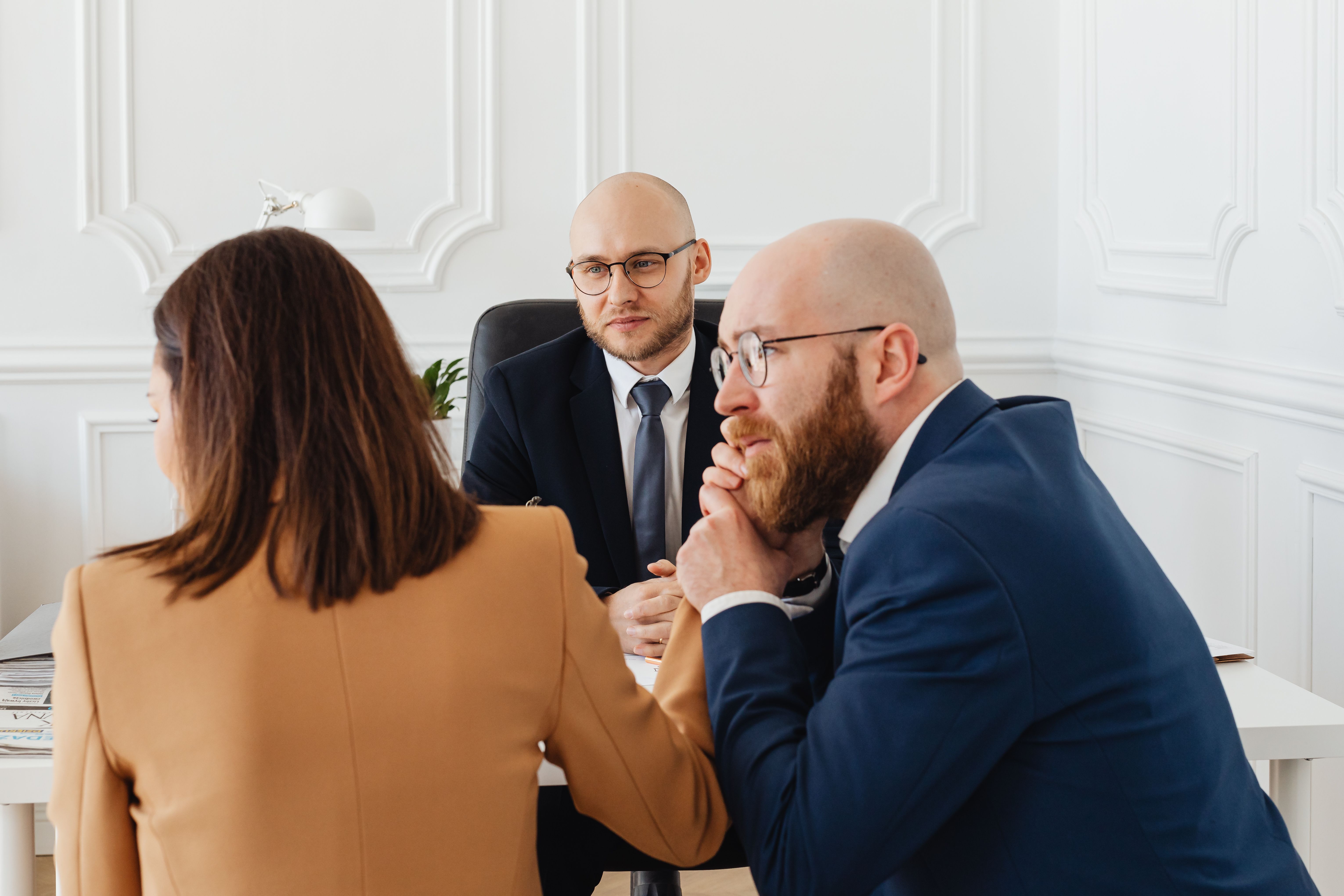 Lawyers consulting with clients in a modern office setting
