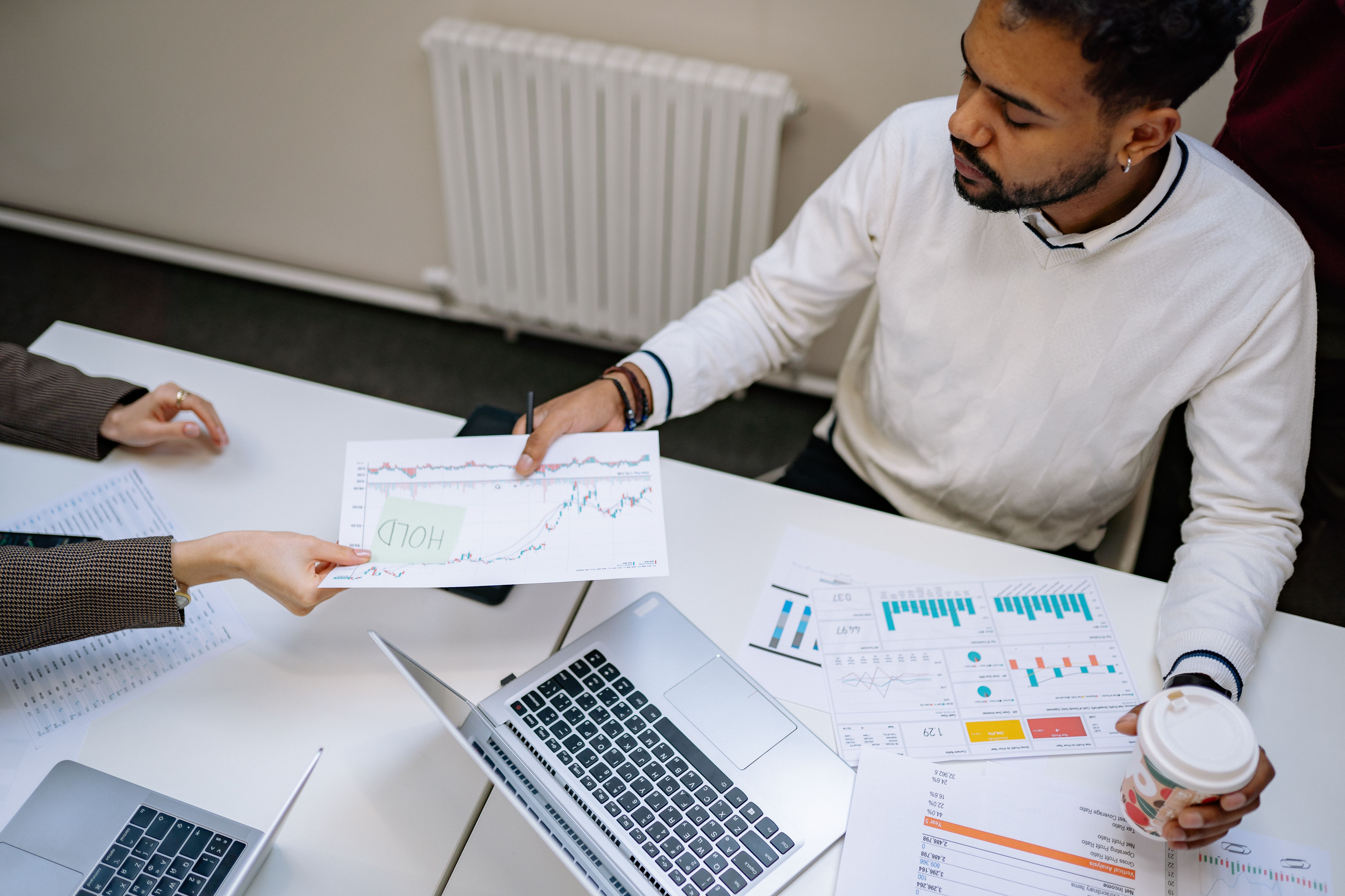 Colleagues reviewing financial charts and data during a business planning meeting